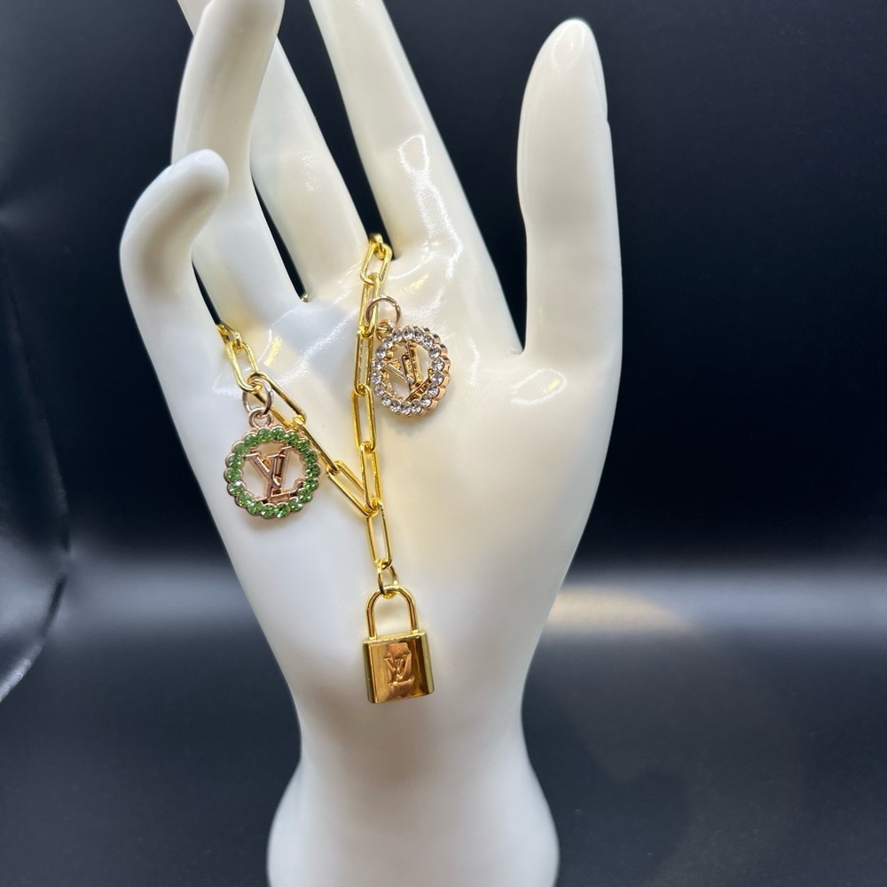 3 pre loved zipper pull charms on a 14kt coated sterling silver bracelet